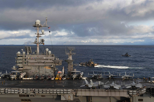 Royal Norwegian Navy Corvettes ride alongside The U.S. Navy aircraft carrier USS Hary S. Truman during flight operations supporting Exercise Trident Juncture 2018 off the coast of Vestfjordern. 